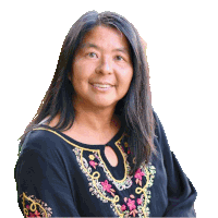 a woman wearing a black shirt with a floral embroidered neckline smiles for the camera