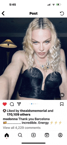 a phone screen shows a picture of madonna and the words liked by theaidsmemorial and 170,109 others