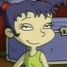 a cartoon girl with purple hair and a green tank top is standing in front of a blue trunk .