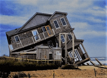 a large house is sitting on top of each other on a beach .