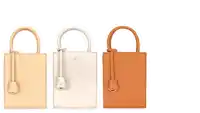 four different colored handbags are lined up next to each other on a white background