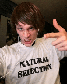 a man wearing a shirt that says natural selection on it