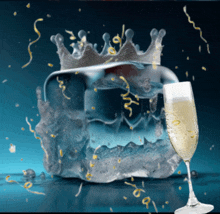 a glass of champagne sits next to a crown shaped ice cube