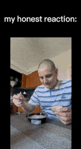 a man in a striped shirt is sitting at a table with a bowl of food and a spoon in his hand