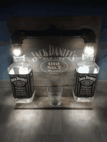 two bottles of jack daniel 's old no.7 whiskey on a wooden shelf