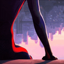 a close up of a person 's leg with a city skyline in the background