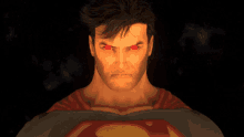 a close up of superman 's face with red eyes and the letter s on his chest