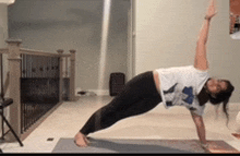 a woman is doing a plank on a yoga mat .