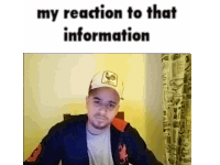 a man wearing a hat with a rooster on it is sitting in front of a wall with the words " my reaction to that information "