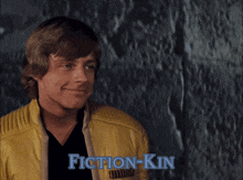 a man in a yellow jacket with fiction-kin written in blue