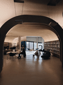 a man sits at a table in a library