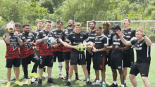 a group of soccer players are posing for a photo and one of their shirts says ' warriors ' on it