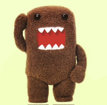 a stuffed animal with a red mouth and teeth