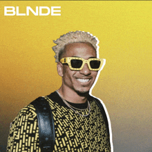 a man wearing sunglasses and a yellow shirt with the word blinde on the bottom