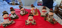 a group of snowmen are sitting on a table with christmas decorations .