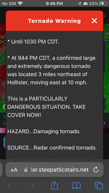 a cell phone screen shows a tornado warning