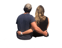 a man and a woman sit with their arms around each other