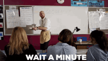 a man in an apron is standing in front of a white board with the word geography written on it