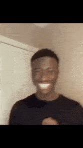 a blurry picture of a man making a funny face while standing in front of a door .