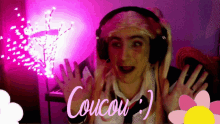 a person wearing headphones says coucou in pink