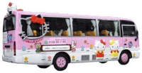 a pink hello kitty bus with a red bow on top of it