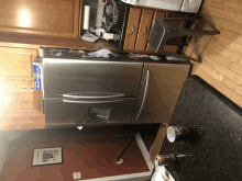 a kitchen with a stainless steel refrigerator and a can of coke on the counter