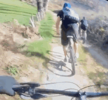 a man riding a bike down a dirt path