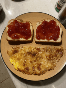 two slices of toast with strawberry jam on them next to an omelet