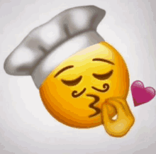 a smiley face wearing a chef hat is blowing a kiss .