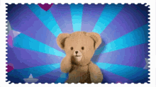 a teddy bear is sitting in front of a blue background