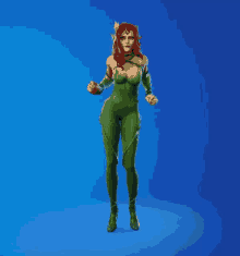 a woman in a green costume with red hair is standing in front of a blue background .