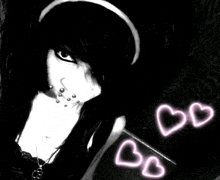 a black and white photo of a girl with two pink hearts in the background