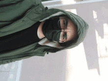 a person wearing a mask and glasses with a hood