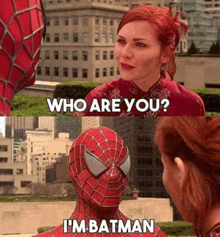 a woman is talking to a man in a spiderman costume who says i 'm batman