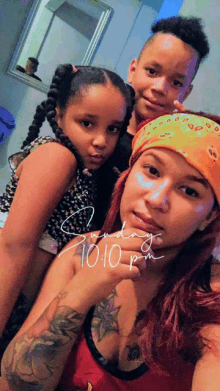 a woman and two children pose for a picture on sunday october 10th