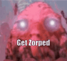 a close up of a pink monster with purple eyes and the words `` get zorped '' written on it .