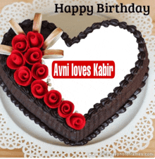 a heart shaped birthday cake with red roses and the name avni loves kabir