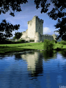 a castle is reflected in a body of water with the words laska below it