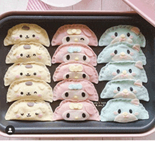 a tray of dumplings in the shape of animals including pompompurin