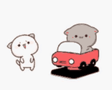 a cartoon cat is sitting in a red car next to a cartoon cat .