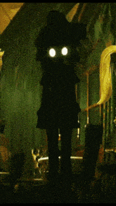 a silhouette of a witch with glowing eyes