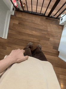 a person standing on a wooden floor next to a gate