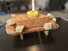 a piece of bread with a candle in the middle of it