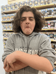 a young man wearing a grey sweatshirt that says new york on it