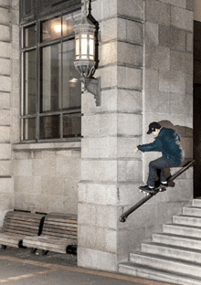 a skateboarder is doing a trick on a set of stairs in front of a brick building