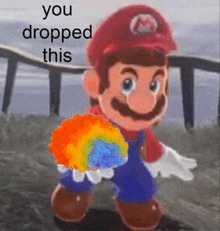 a cartoon of mario holding a rainbow candy with the words `` you dropped this '' written on it .