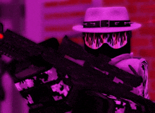 a person wearing a purple hat and holding a rifle