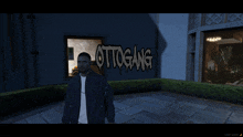 a man is standing in front of a building with ottogang written on it