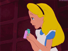 a gif of alice from alice in wonderland holding a bottle