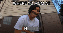 a man in front of a house with the words where yo mom at n